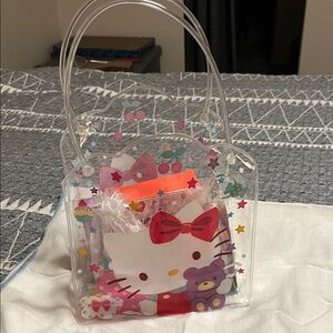A Sanrio Hello Kitty Clear Vinyl Tote with Red Bow filled with girls misc!